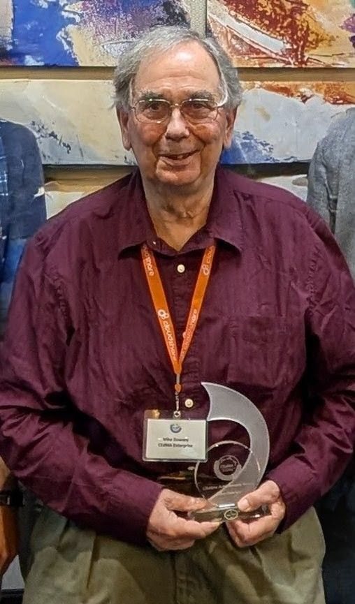 Mike Dowsey holding the Lifetime Achievement Award