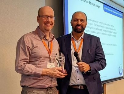 Paul Thompson receiving the Service Award from Faez Ahmed